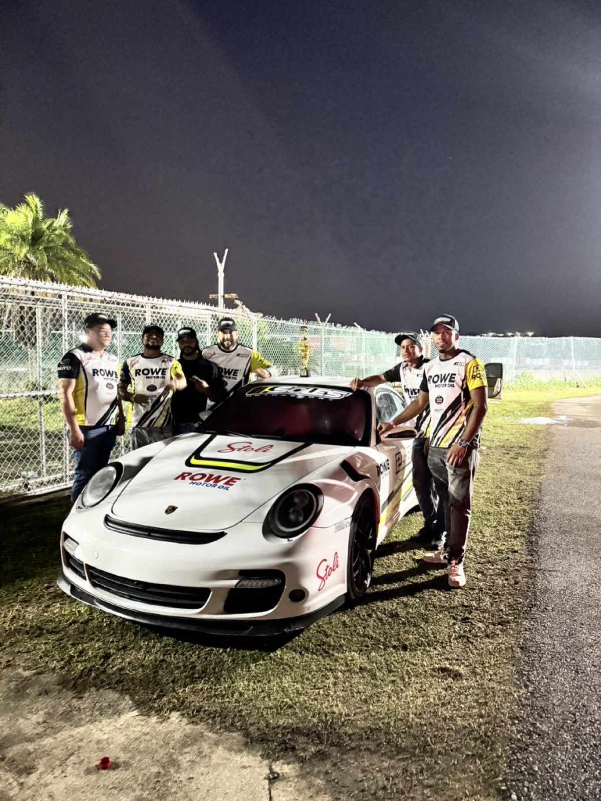 The 9Eleven team with their Porsche 911 race car at the track